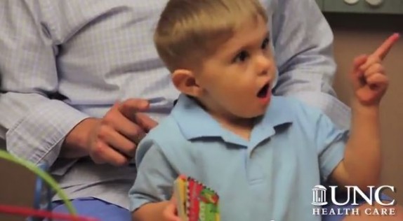 Grayson Clamp pointing as he hears father's voice; Photo courtesy UNC Hospitals