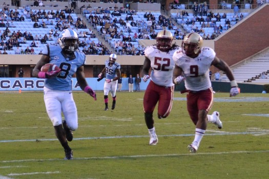 Freshman Tar Heel T.J. Logan tries to break loose near the sideline.